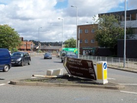 Forlorn looking brown sign This dedicated brown sign is still manages to do it's job despite suffering such shocking injuries